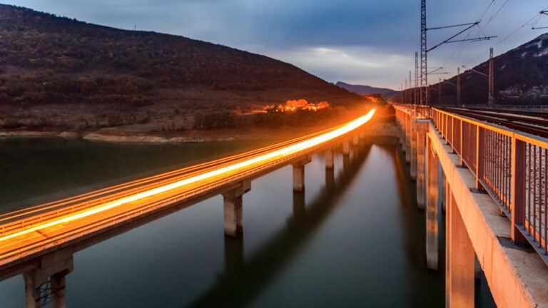 С влак из България